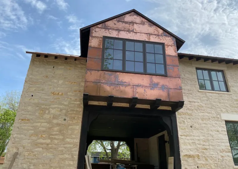 Copper metal panel facade on a stone building for Roof Repair in Oceanside